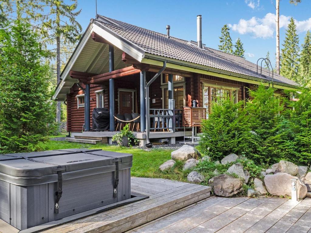 a small house with a hot tub in front of it at Holiday Home Villa usva by Interhome in Kolinkylä