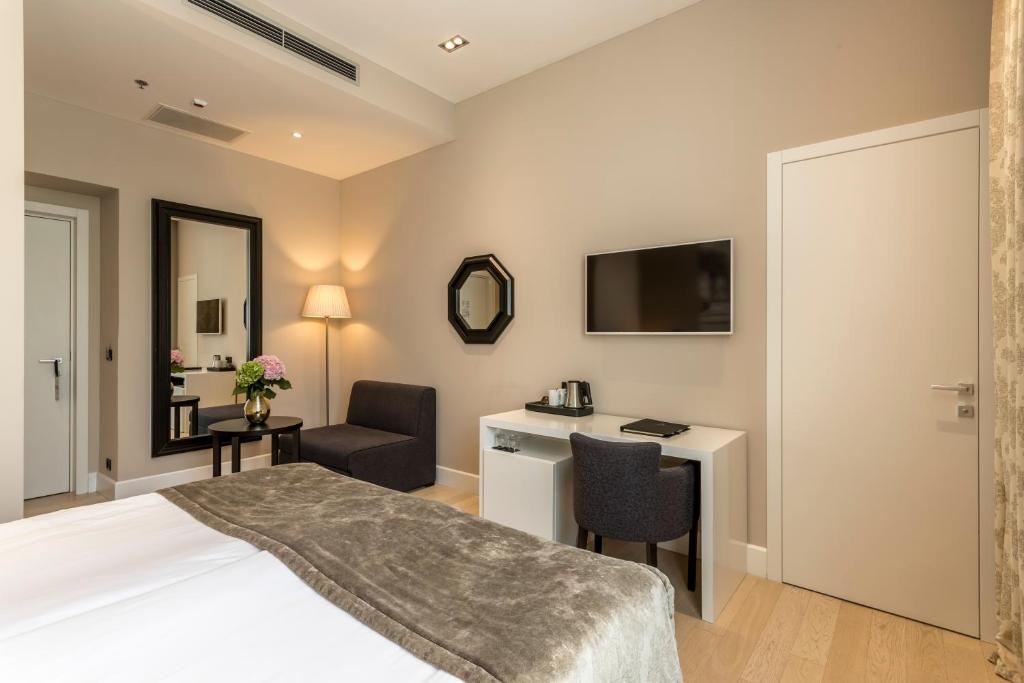 Posteľ alebo postele v izbe v ubytovaní Cornaro Hotel