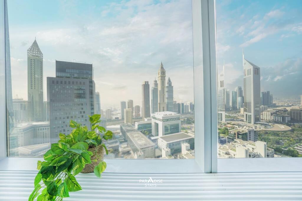 a window with a view of a city skyline at Sky Gardens DIFC - Sea & City Views in Dubai