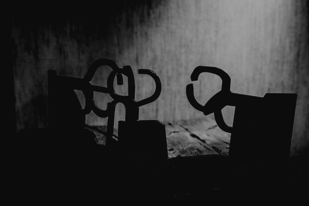 a black and white photo of two cups in the dark at Hotel Atari in Donostia-San Sebastián