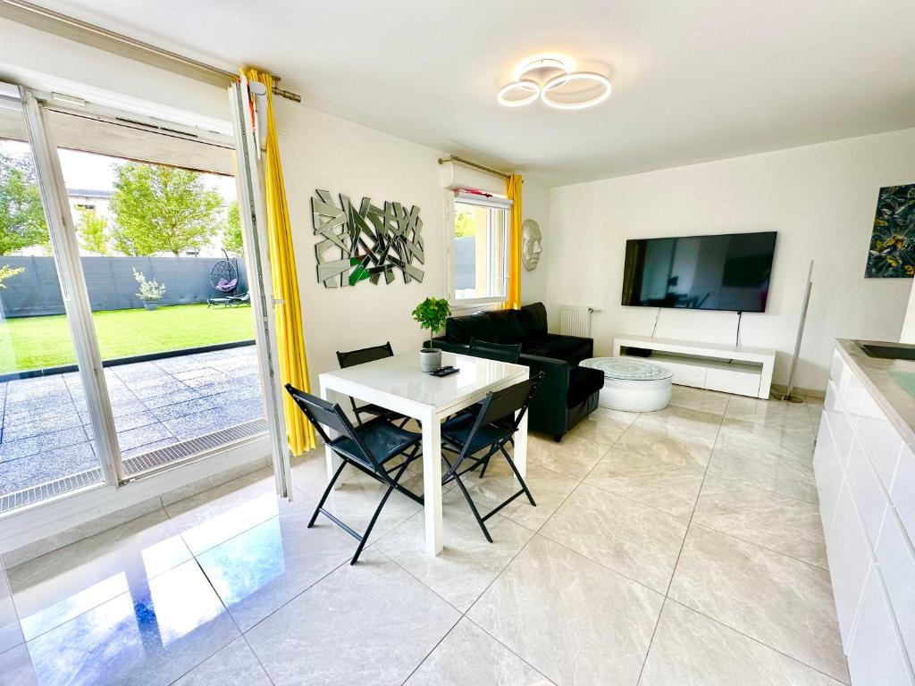a living room with a table and chairs at Stylish Apartment Disneyland Paris in Chessy