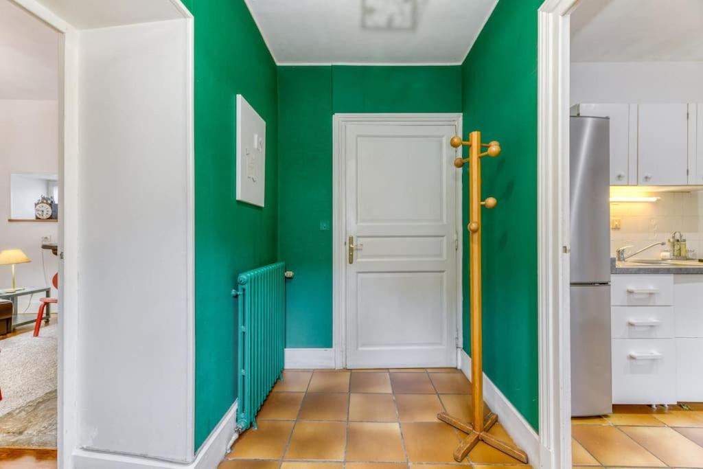 a kitchen with green walls and a white door at Le Charme Antique¶ Belle maison¶ Centre Gières in Gières