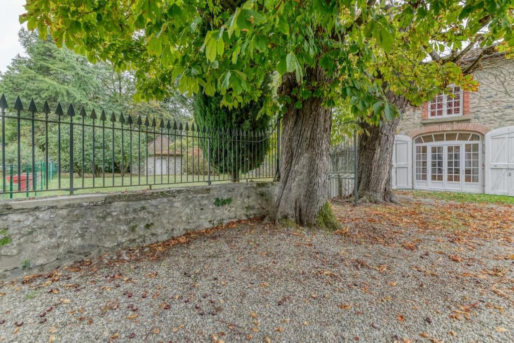 two trees in front of a fence at Le Charme Antique¶ Belle maison¶ Centre Gières in Gières