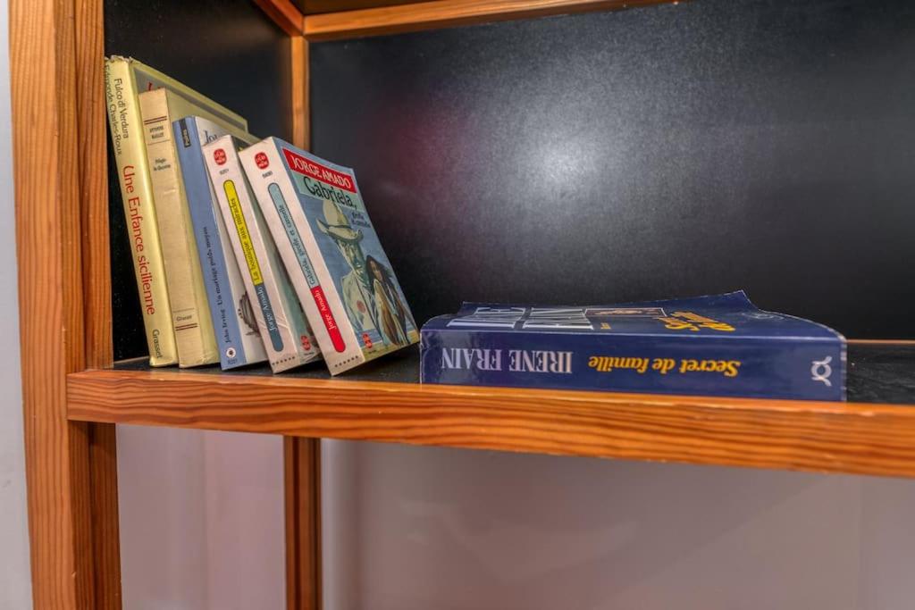 a wooden book shelf with books on it at Le Charme Antique¶ Belle maison¶ Centre Gières in Gières