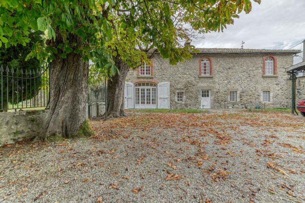 a large stone house with two trees in the yard at Le Charme Antique¶ Belle maison¶ Centre Gières in Gières