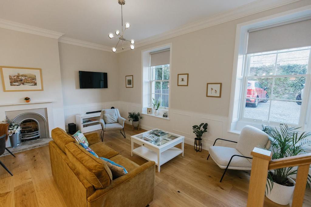a living room with a couch and a fireplace at WENSLEYDALE, OLD SCHOOL ROOMS - Ground Floor Luxury Apartment in Richmond, North Yorkshire in Richmond