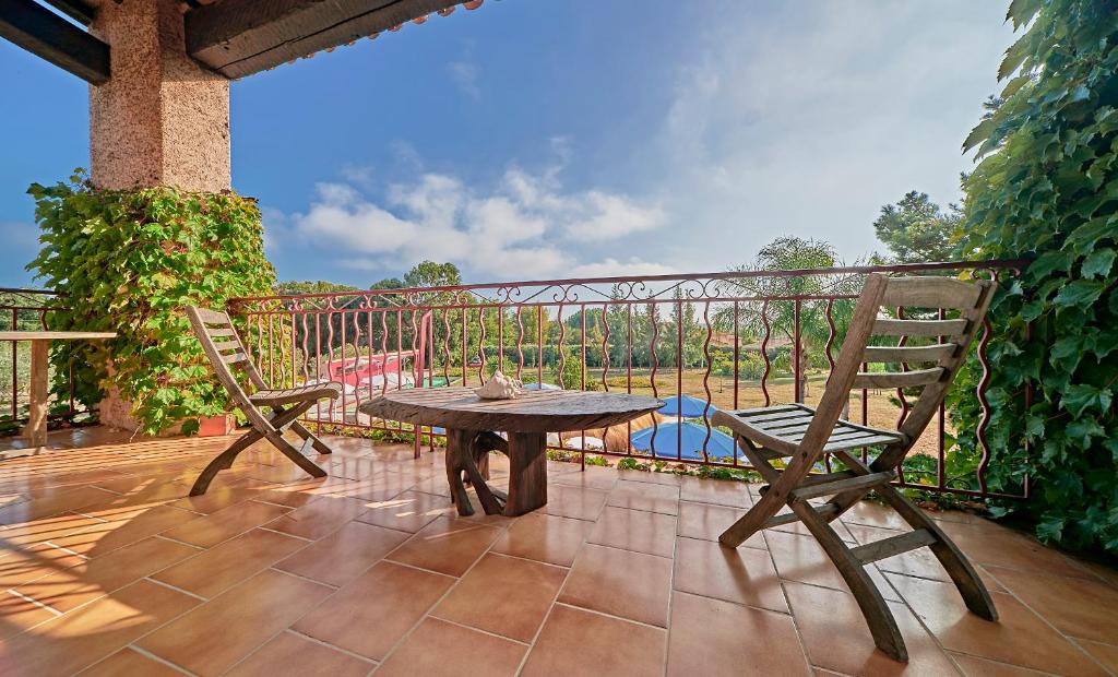 a patio with a table and two chairs on a balcony at VILLA MERCEDES 300 m de la plage in La Londe-les-Maures