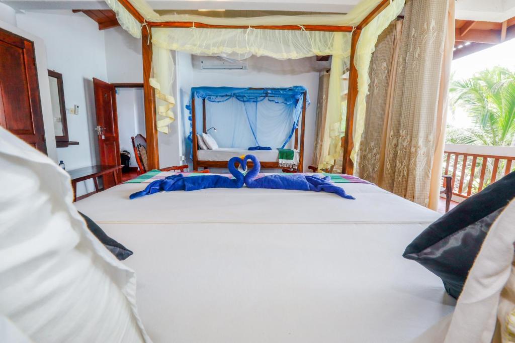 Postel nebo postele na pokoji v ubytování Unawatuna Beach House