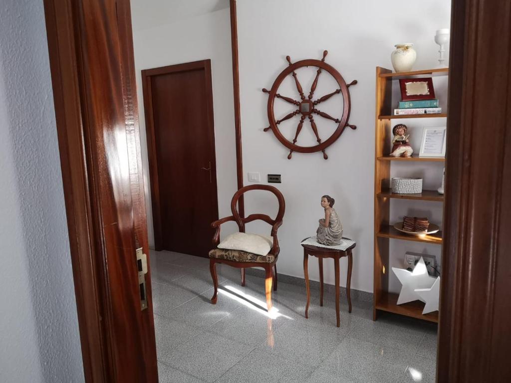 une chambre avec une chaise et une roue sur le mur dans l'établissement Vivienda el Timón, à Ingenio