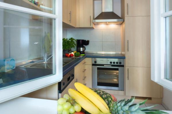 a kitchen with a counter top with fruits and vegetables at Ferienwohnung Hafenglück 13 in Überlingen