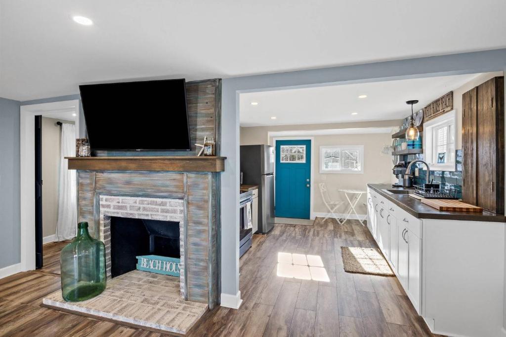 a kitchen with a fireplace with a tv on top of it at White Horse Beach House: Plymouth in Plymouth