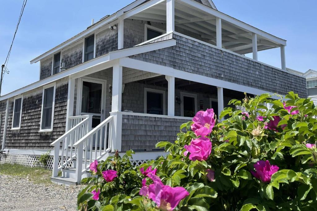a house with pink flowers in front of it at Glades Manor: Minot Beach Scituate in Scituate