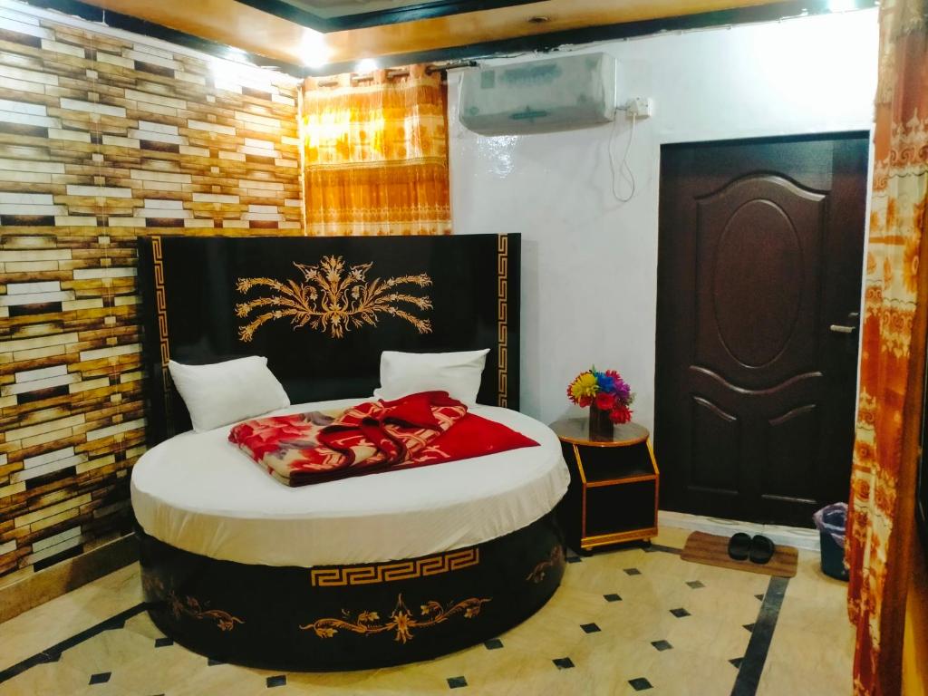 a bedroom with a large bed in a room at Faizan Hotel in Lahore