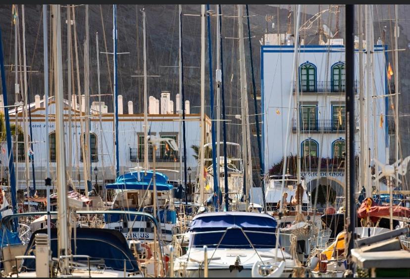 a bunch of boats docked in a harbor at OMBÚLAFUENTE in Puerto de Mogán