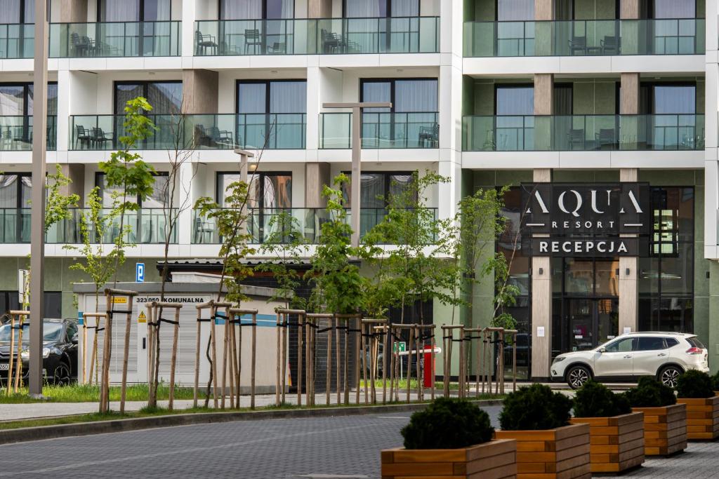 an apartment building with a sign for a hotel at Bel Mare Aqua Resort in Międzyzdroje