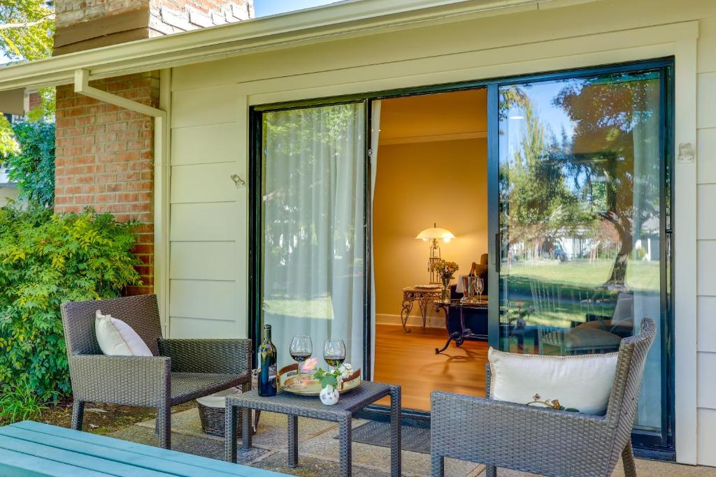 a screened in porch with two chairs and a table with wine glasses at Serene Napa Retreat with Pool Access and Patio! in Napa