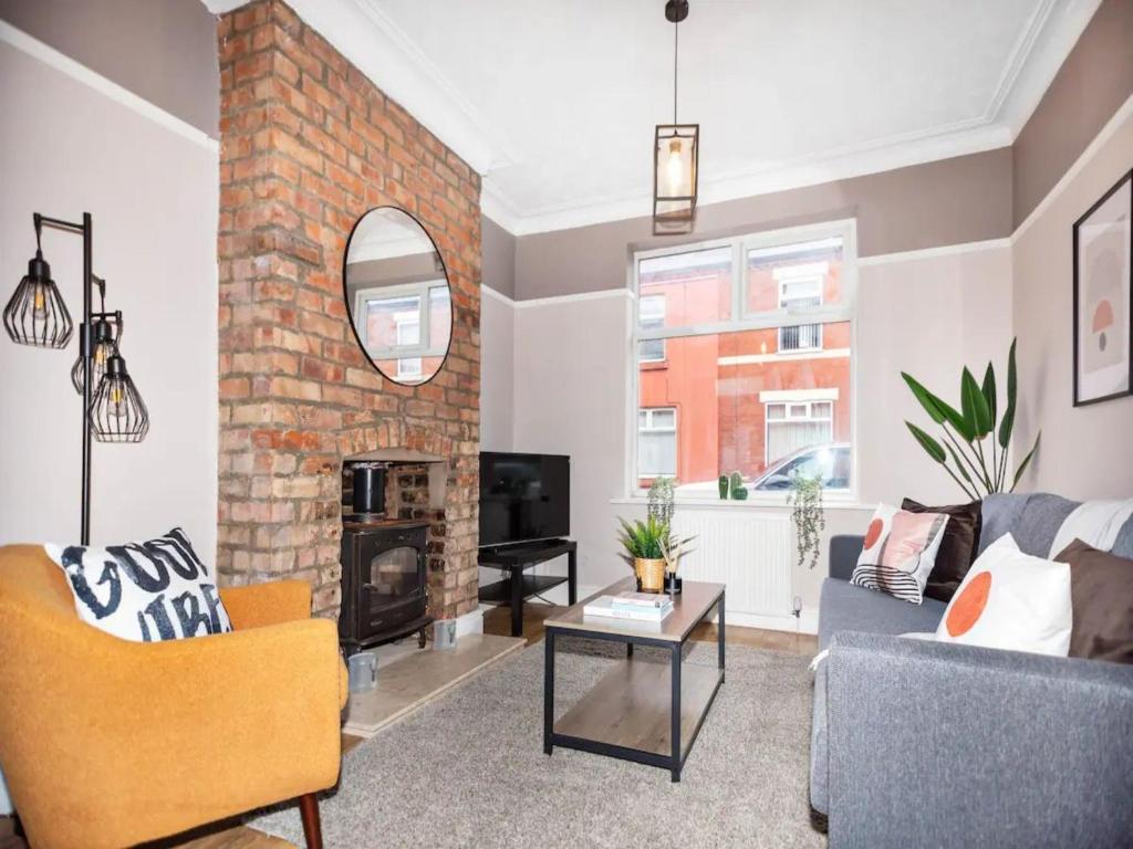 a living room with a couch and a fireplace at Pass the Keys Beautifully refurbished home close to City in Manchester