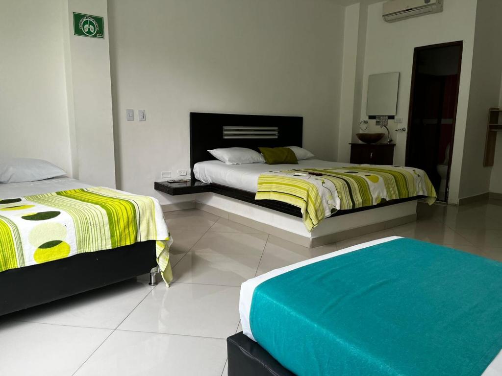 Postel nebo postele na pokoji v ubytování Hotel Laureles Park