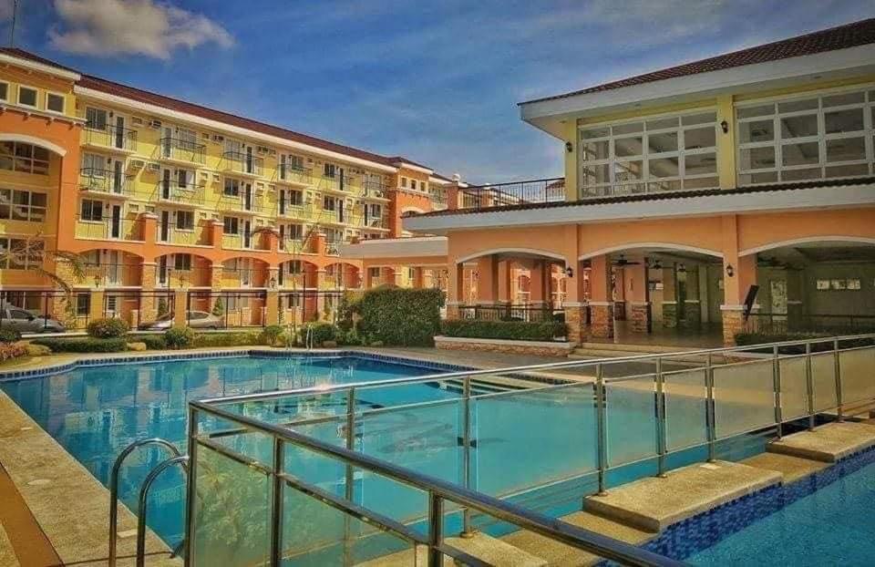 a large swimming pool in front of a building at AJ’s Cozy Condo Davao in Davao City