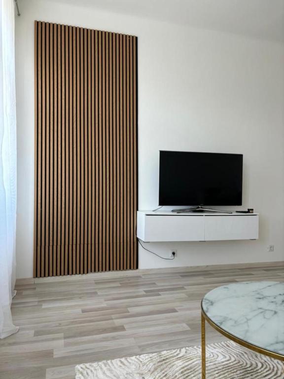 a living room with a flat screen tv on a wall at Apartment Luxury- Contactless Check-In in Vienna