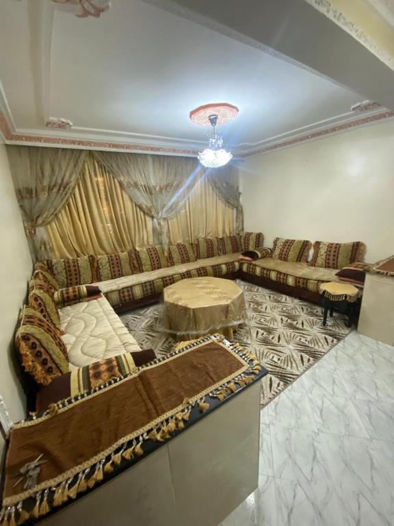 a living room with a couch and a table at Riad salam agadir in Agadir