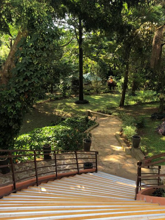 a park with a bench and a walkway at The Address Resort in Kalangala