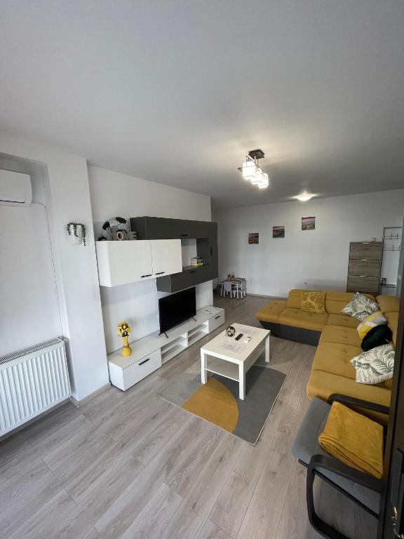 a living room with a couch and a table at Roxi's Apartment in Sibiu