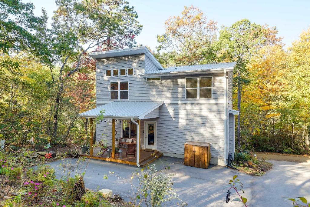 a white house with a porch in the woods at Luxury Mountain Home - by Ridgecrest and Asheville! in Black Mountain