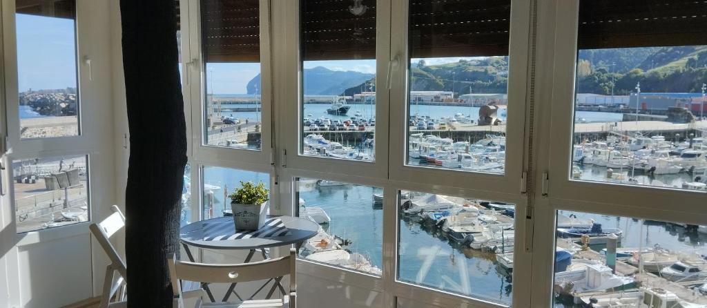 a window with a view of a marina at Andra Mari Portua in Bermeo