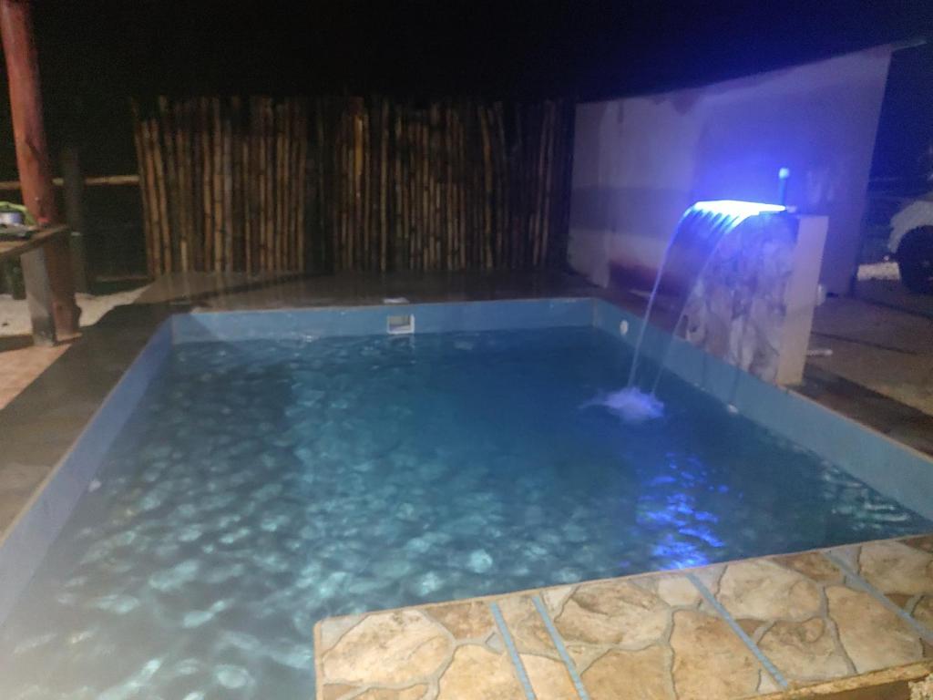 a swimming pool at night with a water fountain at Villas El Alto 3 in Tambor
