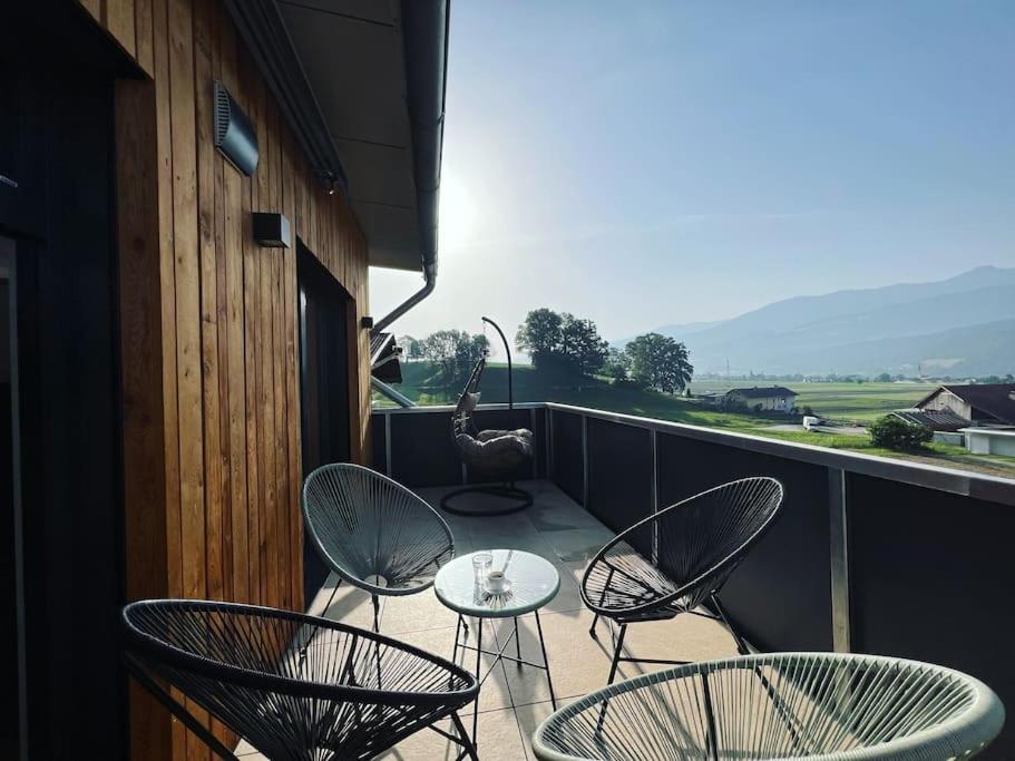 a balcony with chairs and a table on a balcony at Bergpanorama Lodge — Alpenidylle in Thaur