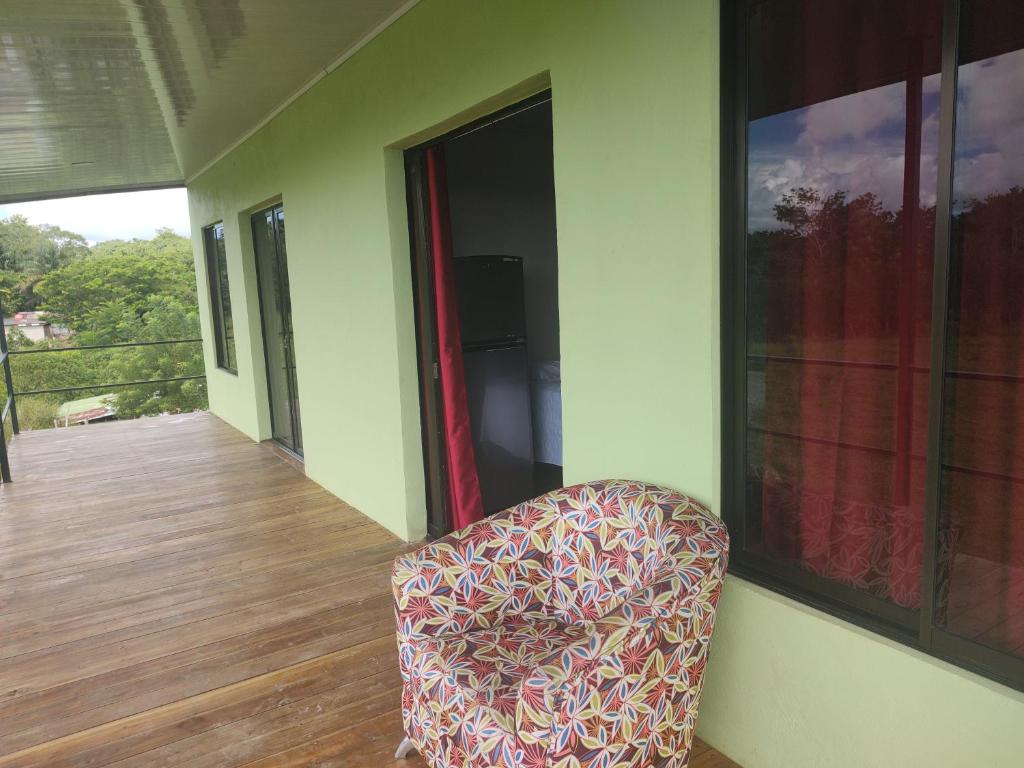 a chair sitting on the porch of a house at Villas El Alto 1 in Tambor