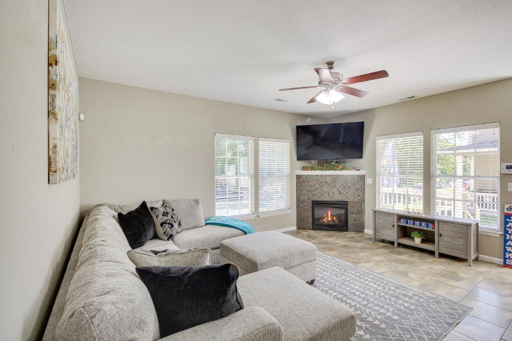 a living room with a couch and a fireplace at Lovely Lawrence Home - 3 Blocks to KU! in Lawrence