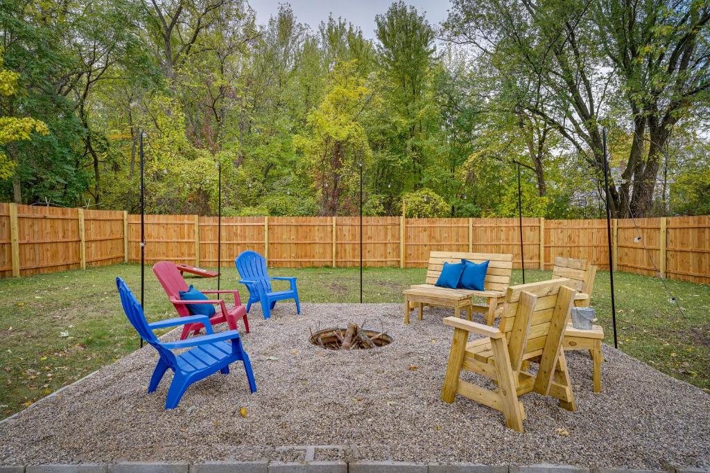 a group of chairs and a fire pit in a backyard at Cozy Hart Getaway with Fire Pit Less Than 1 Mi to Lake! in Hart