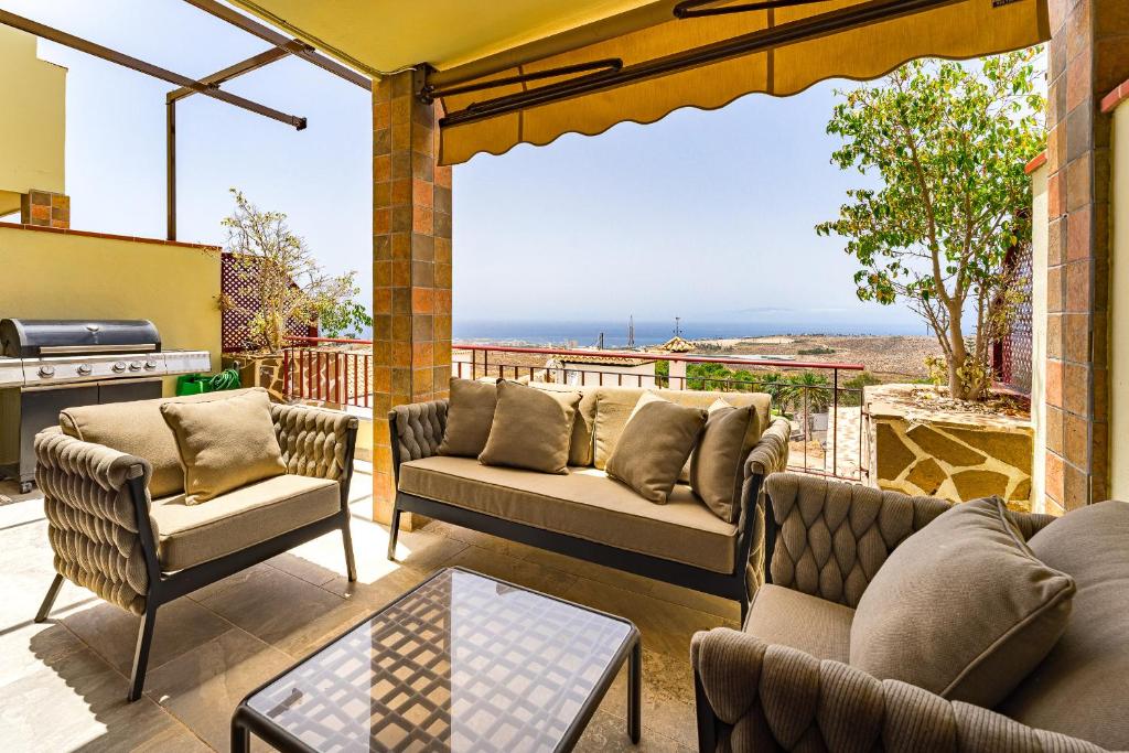 a patio with couches and a view of the ocean at Casa Alma El Condor Chayofa in Chayofa
