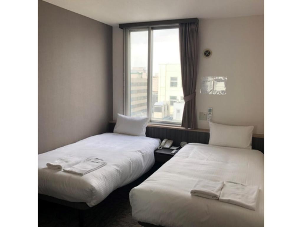 En eller flere senge i et værelse på HOTEL TETORA ASAHIKAWA EKIMAE - Vacation STAY 91497v