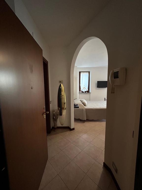 a room with a bed and a room with an open door at AleGio Home in Zelo Buon Persico