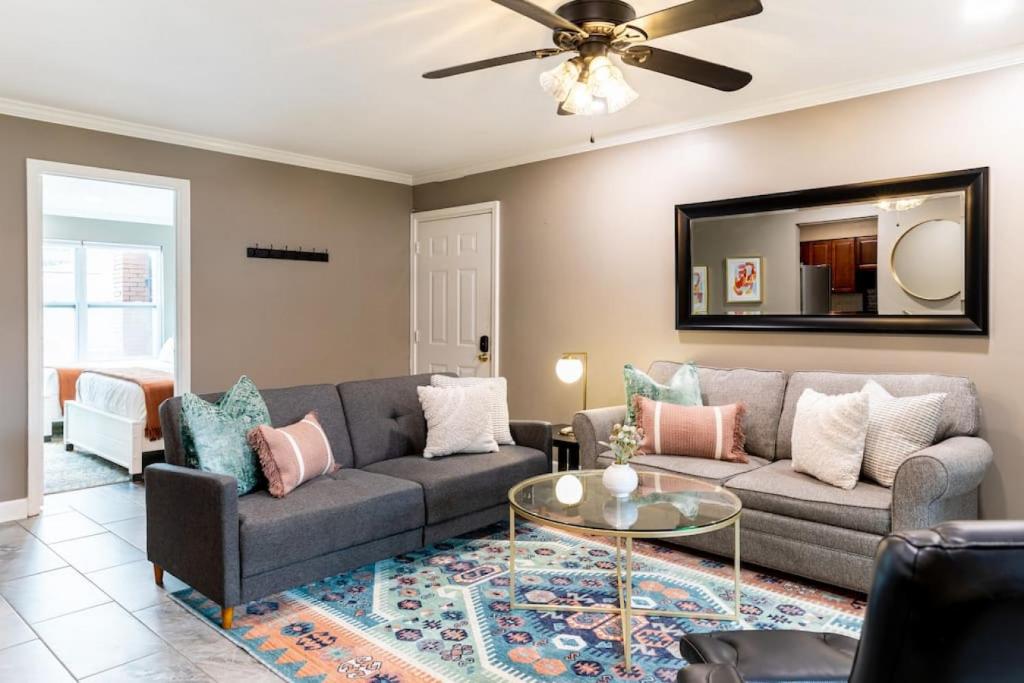 a living room with a couch and a table at Downtown Nashville Condo, Walk to Broadway with Free Parking in Nashville