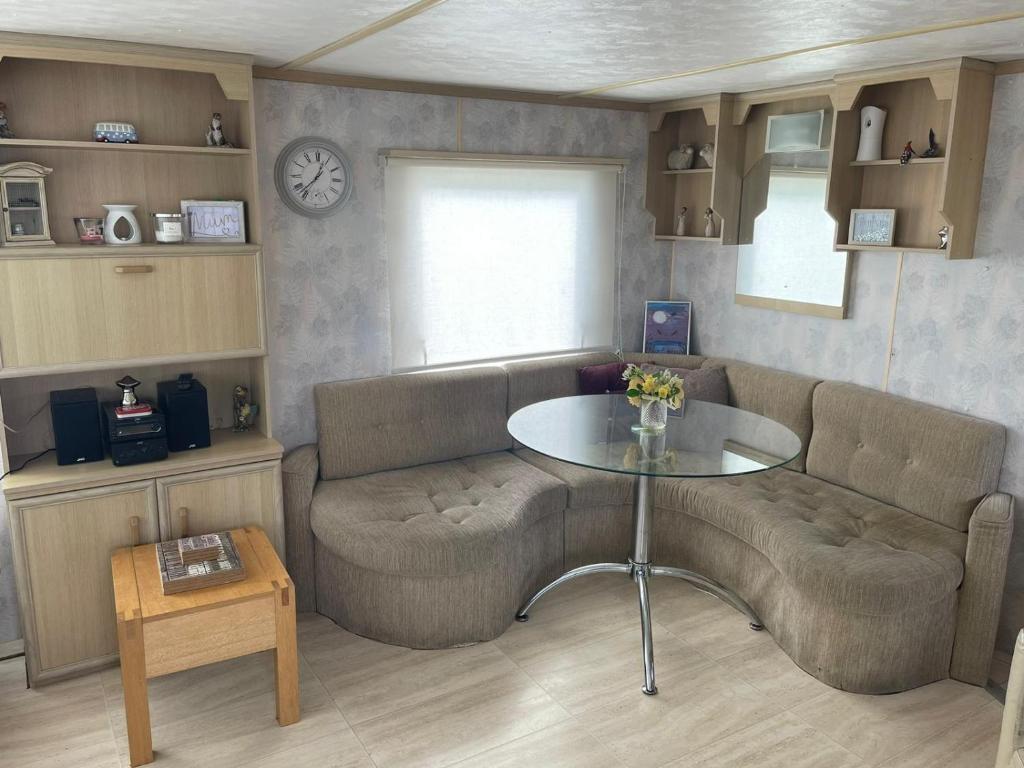a living room with a couch and a table at Lake District Caravan in Cockermouth