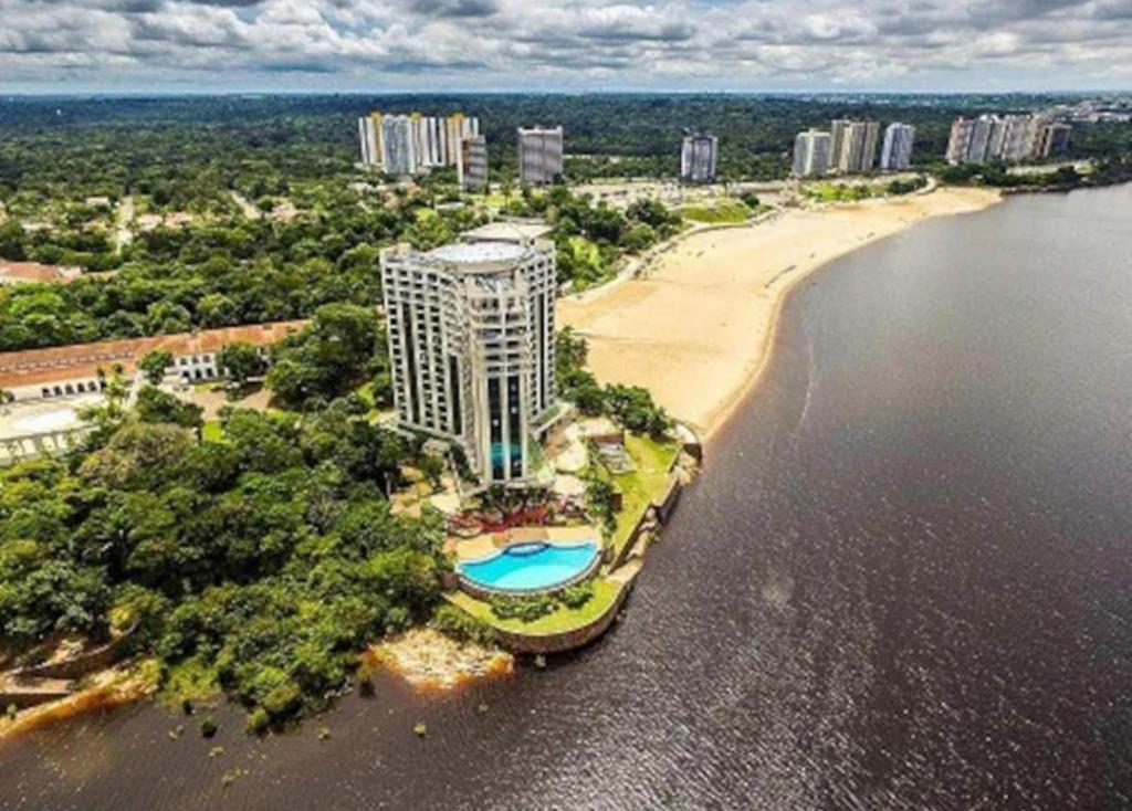 an aerial view of a building next to a beach at Hotel Tropical Executive Flat 020 in Manaus