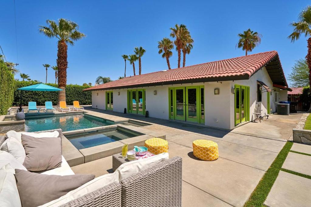 a villa with a swimming pool and a house at Pineapple Splash! Complete Privacy! Salt Pool! in Palm Springs