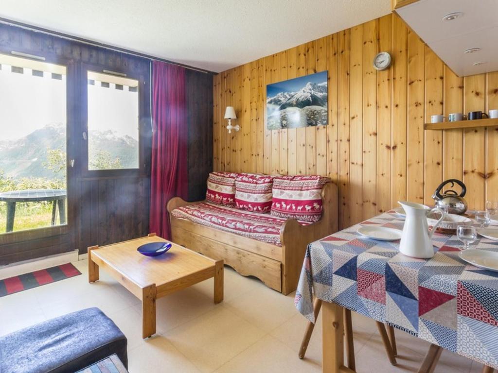 a room with a bed and a table in it at Appartement La Rosière, 2 pièces, 4 personnes - FR-1-275-86 in La Rosière