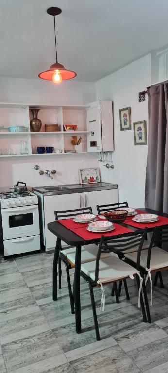 a kitchen with a table and two chairs and a stove at Microcentro Monoambiente Vista in Buenos Aires