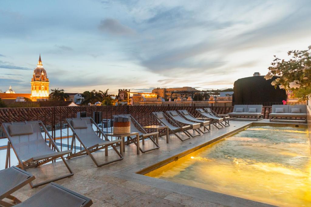 a rooftop patio with chairs and a swimming pool at Hotel Casa Don Luis by Faranda Boutique, a member of Radisson Individuals in Cartagena de Indias