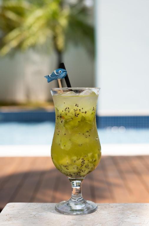 a drink in a glass sitting on a table at Jade Hotel Brasília in Brasilia