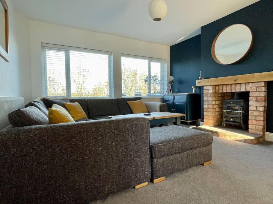 a living room with a couch and a fireplace at Scholes Park Drive, by the Seaside in Scalby