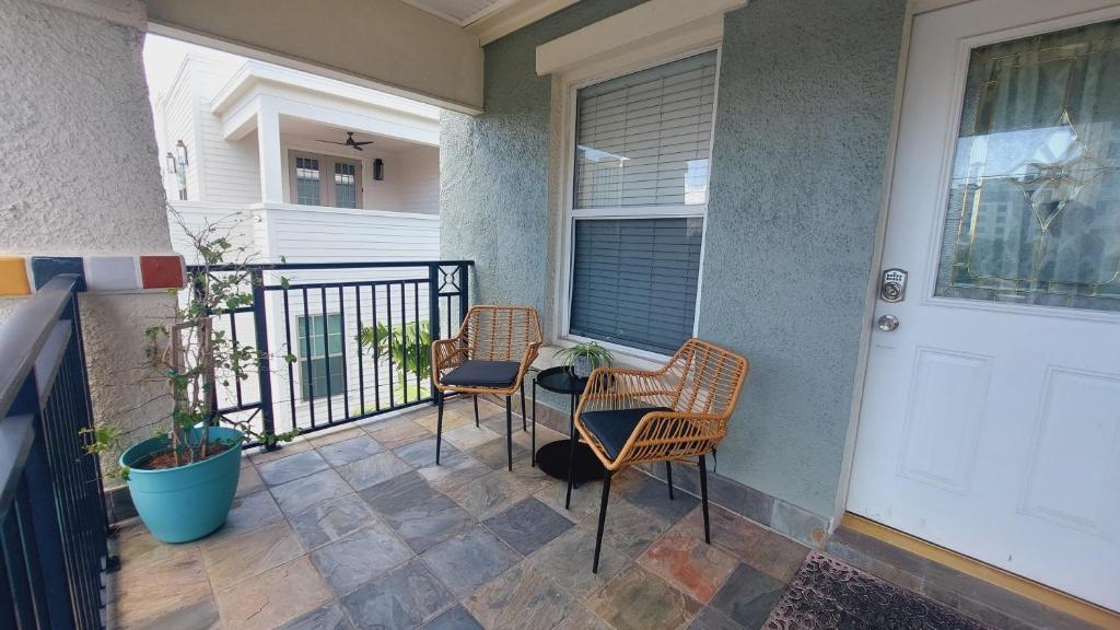 a porch with two chairs and a white door at The Hipster Studio in DTSP in St Petersburg