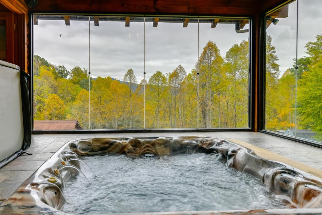 uma banheira de hidromassagem no meio de um quarto com janelas em Home with Indoor Spa 8 Mi to Smoky Mtn Natl Park! em Waynesville