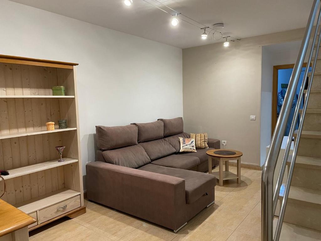 a living room with a couch and a table at Castillo Holiday Home in Caleta De Fuste