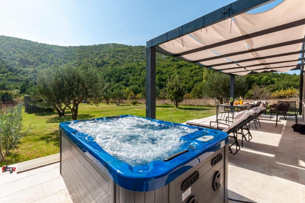 a hot tub on a deck with a view of a mountain at House Madonna di Smovo in Gata
